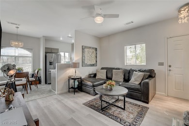 Living area with visible vents, light wood-style f