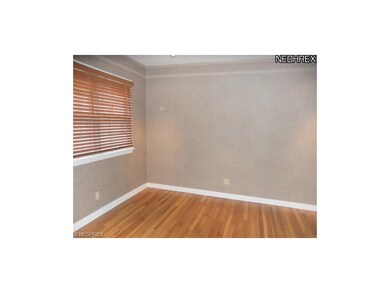 The den features hardwood floors and a great space