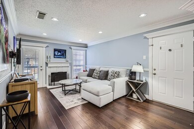 Living room featuring a fireplace, crown molding, 