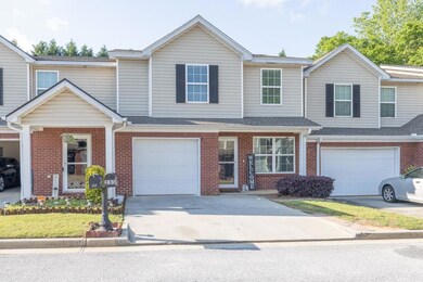 View of front of home featuring driveway, brick si
