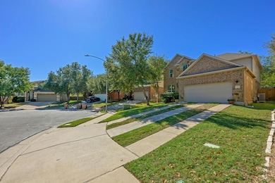 View of front of property featuring brick siding, a garage, and driveway