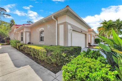 View of side of property with a lush landscaping & stucco siding
