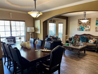 Dining room with arched walkways, ornamental moldi