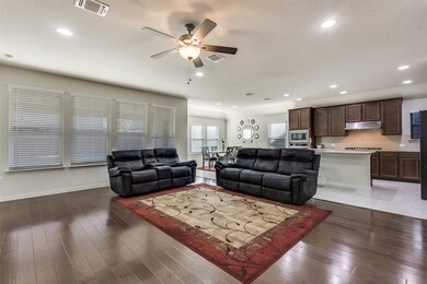Family Room open to Kitchen with hardwood flooring