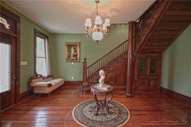 Entry foyer with stained woodwork and fireplace