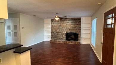 Unfurnished living room with ceiling fan, dark wo
