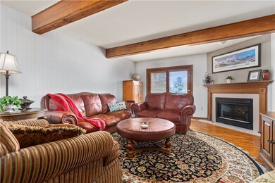 Beamed ceilings, corner fireplace with oak mantle,