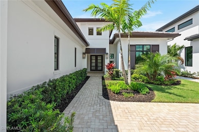 Doorway to property featuring stucco siding and fr