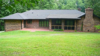 Back brick patio and screened in porch with slate 