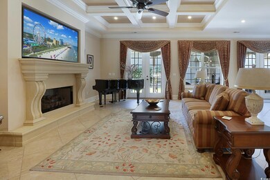 Living room featuring ceiling fan, crown molding, 
