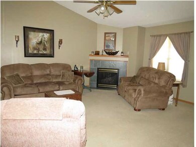 2nd view of living room area which features vaulte