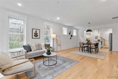 Living room with light hardwood / wood-style floor