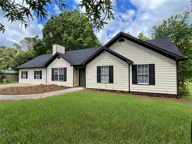 Single story home with a front lawn and a chimney