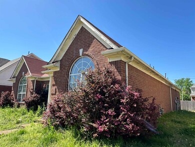View of home's exterior with brick siding and fenc