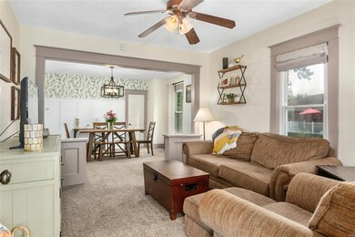 Light filled living room open to the dining room.