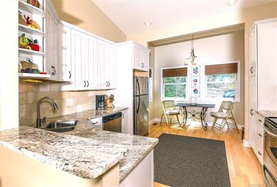 A cozy breakfast nook, surrounded by windows is ju