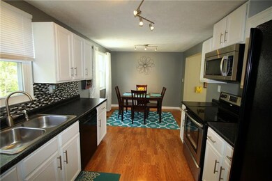 Updated eat-in kitchen with crisp white cabinetry 