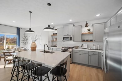 Kitchen with island, pendant lighting and open shelving