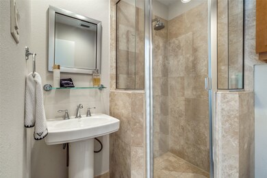 Ensuite guest bathroom with travertine tile