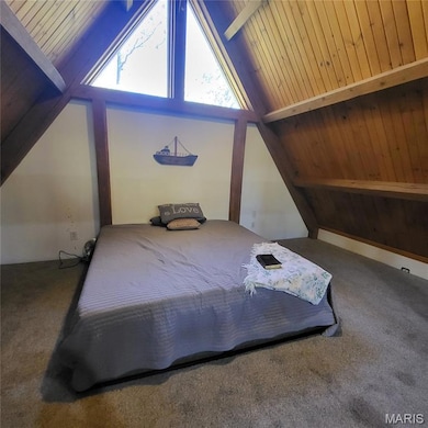 Carpeted bedroom with wooden ceiling