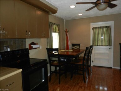 The kitchen with a door leading to the two car att