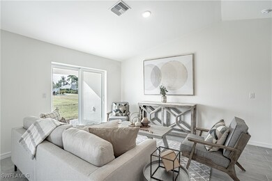 Living area featuring lofted ceiling, wood finishe