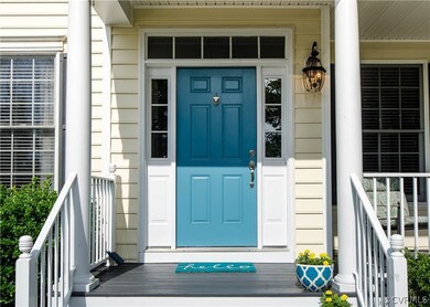 The front porch has a fresh coat of paint and a br