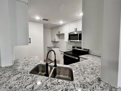 Kitchen featuring white cabinets, visible vents, s