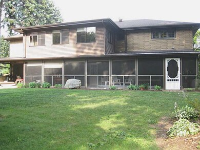 Exterior Back. Enclosed sun porch off kitchen; scr