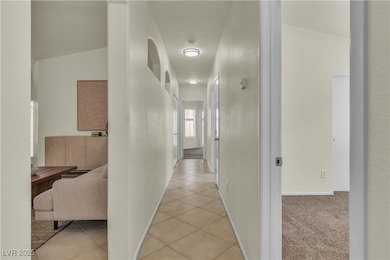 Hallway with light tile patterned flooring