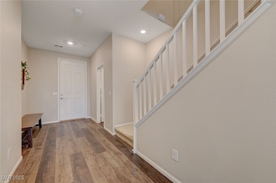 Entryway featuring stairs, wood finished floors, b