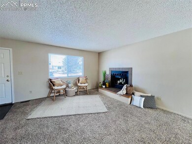 Living room featuring a fireplace, carpet floors.