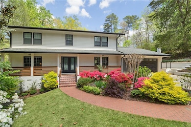View of front of property with french doors, roof 