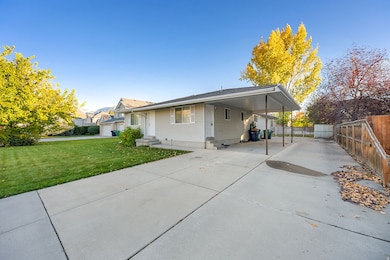 View of front of property with driveway, an attached carport, a patio area, and entry steps