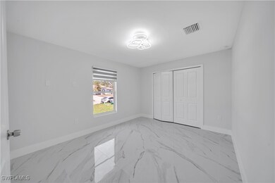 Bedroom featuring baseboards, marble finish floor,