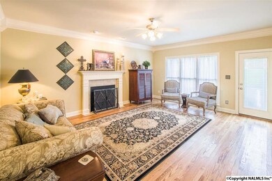 The great room has a gas log fireplace and new hardwood floors.