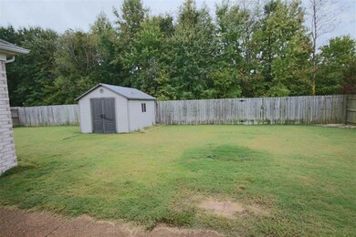 The sprawling backyard is lined by a privacy fence