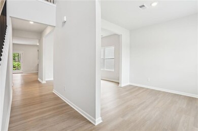 Hall with light wood-style flooring and recessed lighting