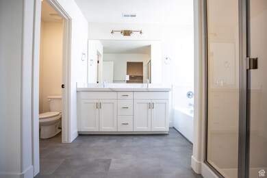 Primary bathroom with separate tub and shower, and separate water closet.