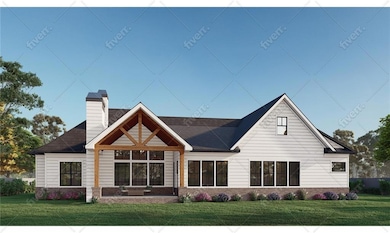 Rear view of house with a lawn, brick siding, and a chimney