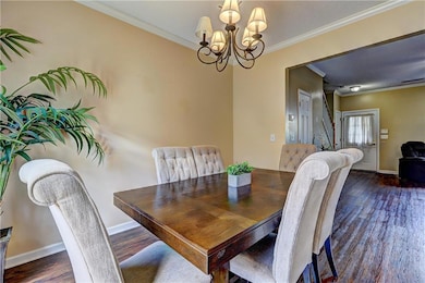 Dining room featuring crown molding, dark wood-sty