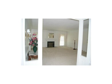 Great room with elegant crown molding and panels.
