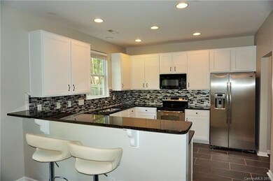 BAR STOOL AREA / GRANITE KITCHEN / CUSTOM TILE BAC