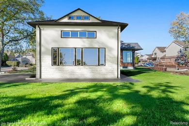 Rear view of property featuring stucco siding, a yard, and stone siding