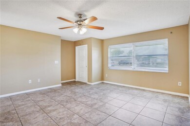 Unfurnished room with a textured ceiling, light tile flooring, and ceiling fan