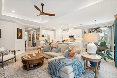 Living area with a ceiling fan, ornamental molding