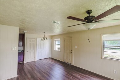 Unfurnished room featuring dark wood-style floorin