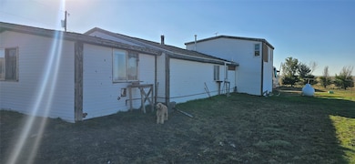 Rear view of property featuring a lawn