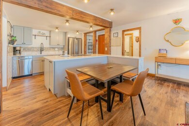 The dining table comfortably seats 4.