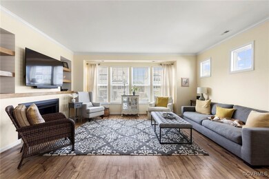 Living room featuring ornamental molding, dark woo